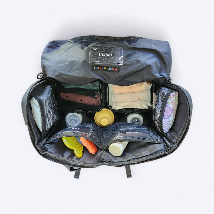 The Medley Baby Bag birds-eye view showing large bag opening and full inside contents