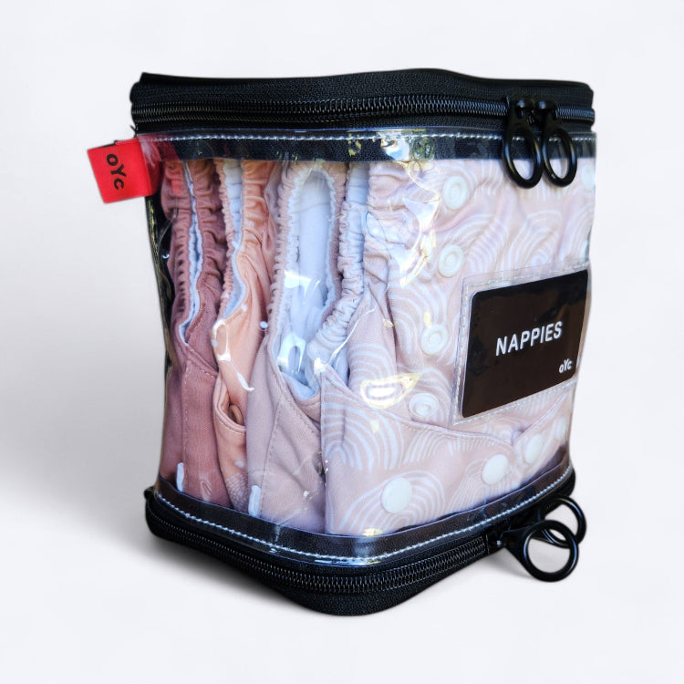 OUT YNDR CLUB wet clothes pod with zipper top and bottom, side angle closed view packed with four modern cloth nappies econaps