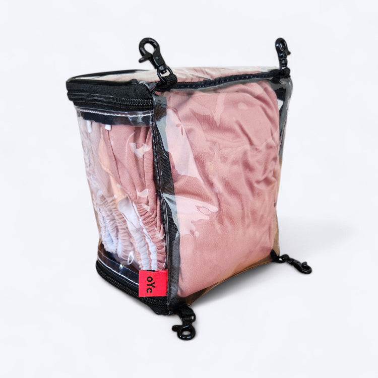 OUT YNDR CLUB wet clothes pod with zipper top and bottom, back angle view packed with four modern cloth nappies
