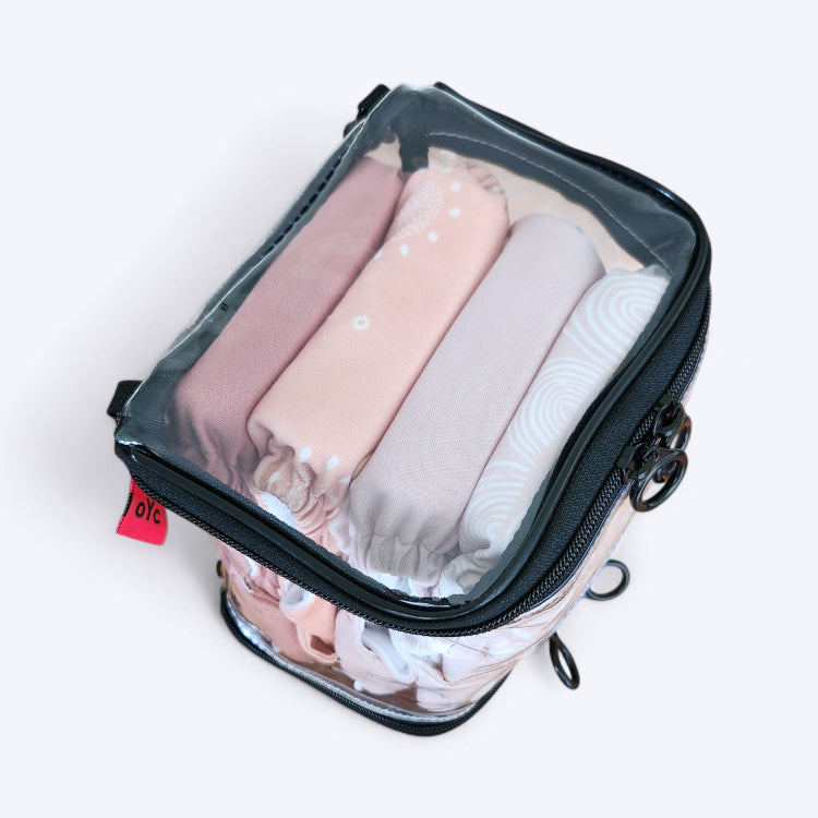 OUT YNDR CLUB wet clothes pod with zipper top and bottom, top view packed with four modern cloth nappies econaps