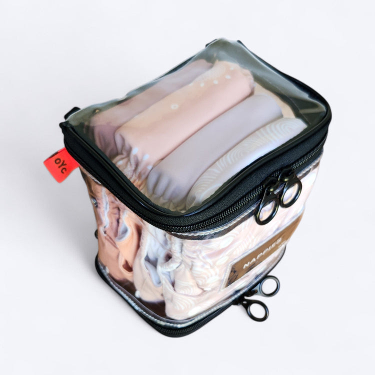 OUT YNDR CLUB wet clothes pod with zipper top and bottom, top angle view packed with four modern cloth nappies