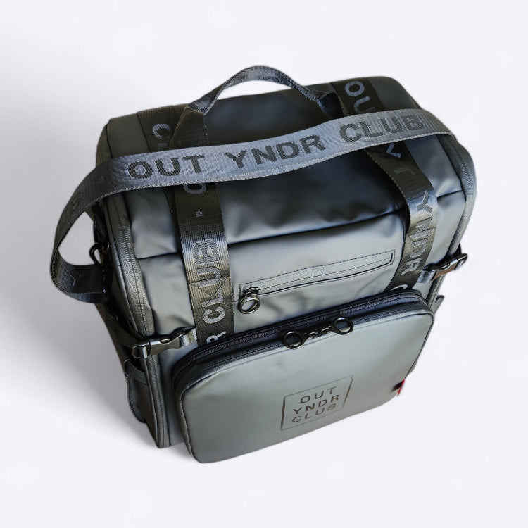 OUT YNDR CLUB Medley baby bag for parents with newborns and young children, black top view with out yndr club embossed straps