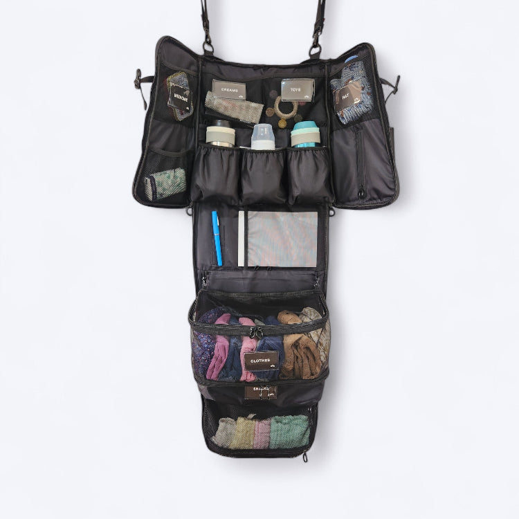 OUT YNDR CLUB Medley baby bag, hanging organiser, black mesh pod, back view filled with children's clothes