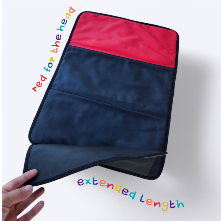 OUT YNDR CLUB Baby change mat with extended length and wipe clean material, black with red panel for the baby head